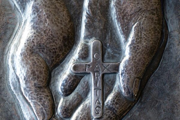 Hands-holding-Madonna-House-Cross-Chase-silver-work-by-Peter-Gravelle