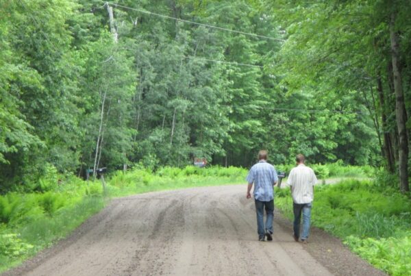 Two people walking down the road